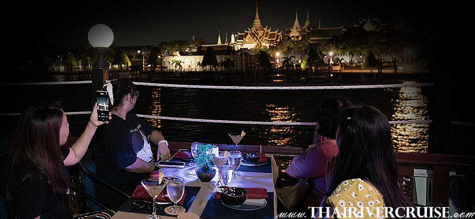 Rice barge cruise Bangkok Mahapatra Cruise Rice Barge Cruise Bangkok Traditional Thai Dinner  Mahapatra Cruise Thai dinner cruise Bangkok Chaophraya river Scenery: As you cruise along the Chao Phraya River, you'll be treated to stunning views of Bangkok's illuminated landmarks, including the Grand Palace, Wat Arun (Temple of Dawn), and various riverside temples and buildings. 